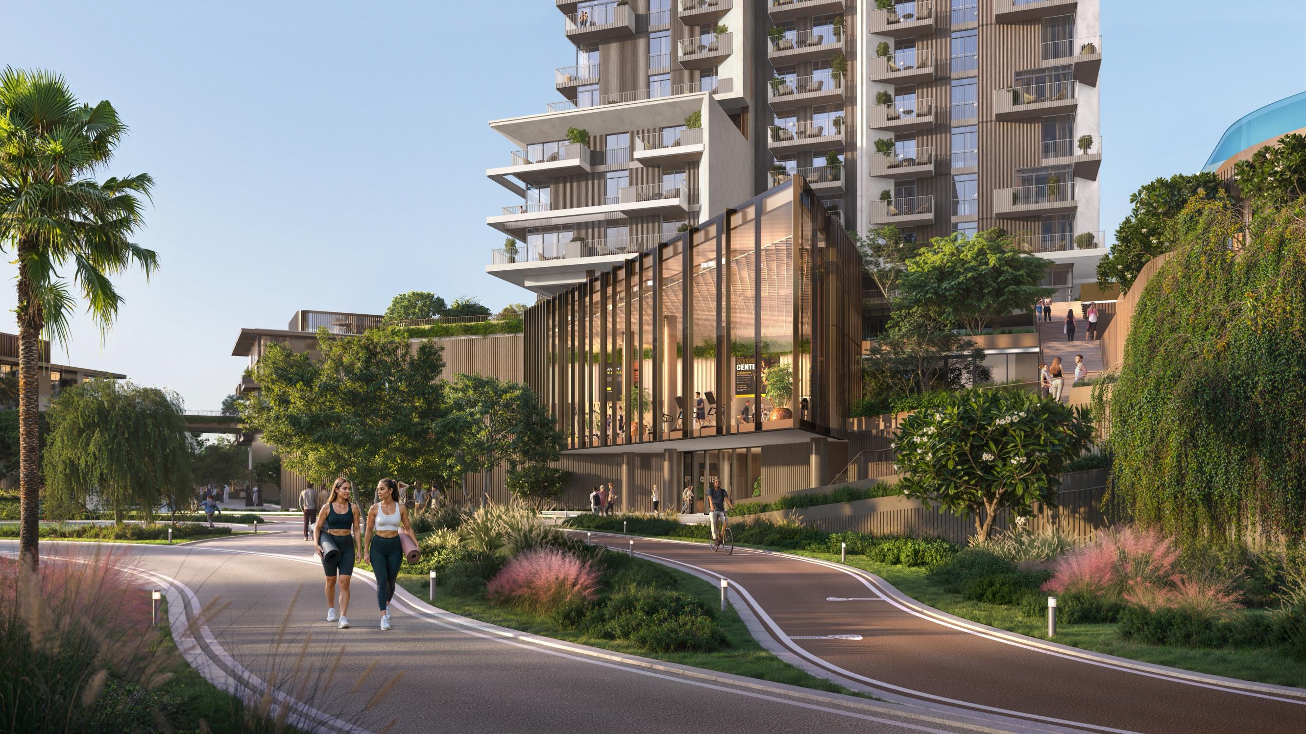 Rise by Athlon Dubailand Dubai tower skyline view surrounded by lush greenery and community wellness amenities